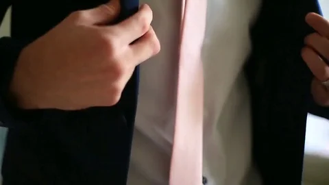 Businessman dons a jacket Stock Footage 81322304