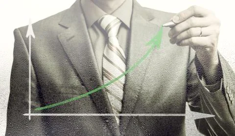 Businessman drawing rising graph, development and growth concept Stock Photos