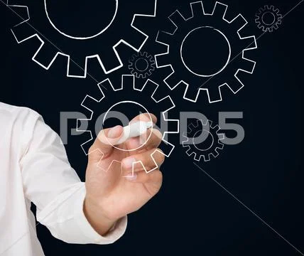 Businessman drawing white cogs and wheels Stock Photos