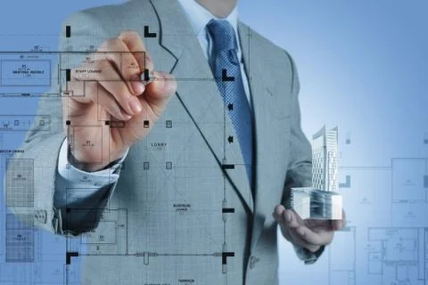 Businessman draws building development Ilustración de archivo