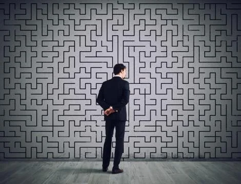 Businessman draws the solution of a labyrinth. Concept of problem solving Stock Photos