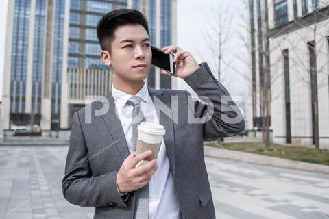 Businessman Drink Coffee Talking To Cellphone At Outdoor