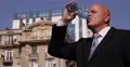 Businessman Drink Water and Wait Associate Meeting Downtown City Center Street 4k or 4k+ Resolution
