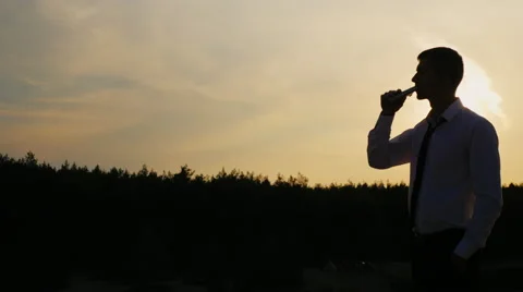 Businessman drinking alcohol from flasks. Concept: business crash, problems Stock Footage 66189945