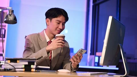 Businessman drinking coffee to get some energy for working overtime sitting.. Stock Footage 313577919