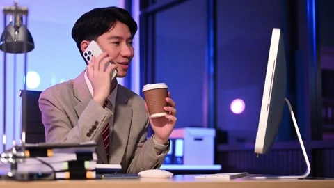 Businessman drinking coffee to get some energy for working overtime sitting.. Stock Footage 313577923