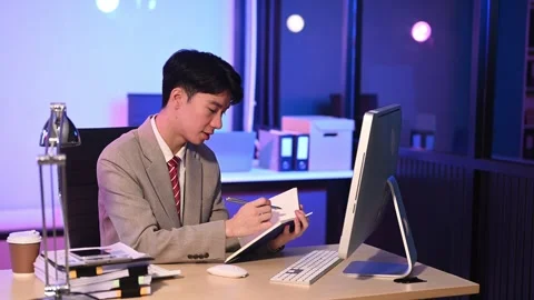 Businessman drinking coffee to get some energy for working overtime sitting.. Stock Footage 313577930
