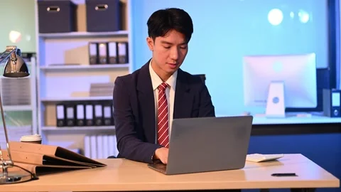 Businessman drinking coffee to get some energy for working overtime sitting.. Stock Footage 313577960