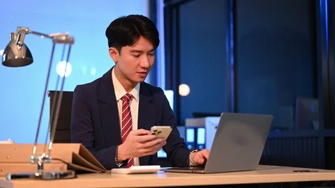 Businessman drinking coffee to get some energy for working overtime sitting.. Stock Footage 313577971