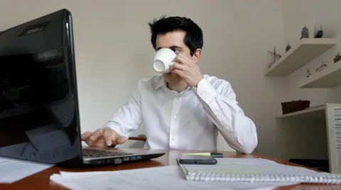 Businessman drinking coffee while working Stock Footage 61513076