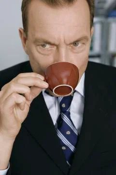Businessman drinking out of coffee cup Stock Photos
