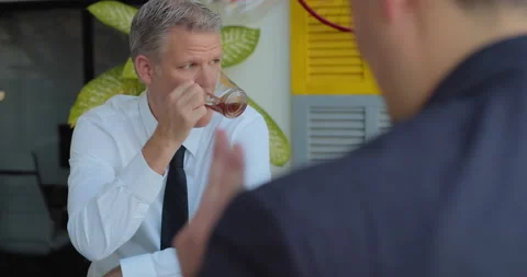 Businessman drinking tea and talking to his colleges during a middle day brea Stock Footage 146201943