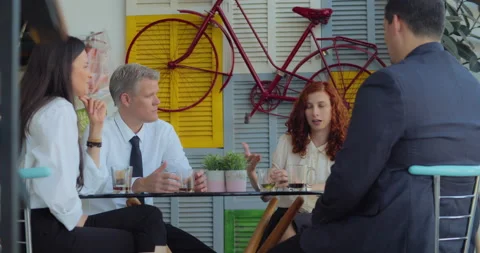 Businessman drinking tea and talking to his colleges during a middle day brea Stock Footage 146202358