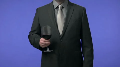 Businessman drinking wine. High definition video shot on blue screen in studio. Stock Footage 45936013