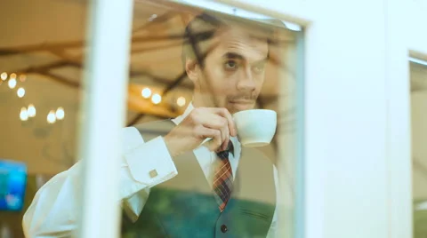 Businessman drinks coffee Stock Footage 62944629