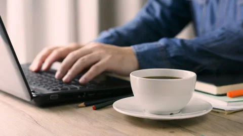 Businessman drinks coffee while working. coffee cup on the desk at home. Stock Footage 138039611