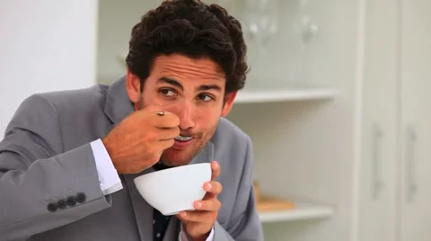 Businessman eating his breakfast quickly Stock Footage