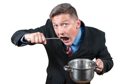 Businessman eats from a pan Stock Photos