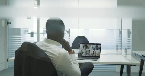 Businessman in empty meeting room using Video Conferencing technology on laptop Video stock 138260976