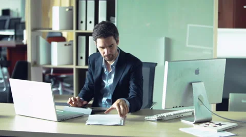 Businessman engrossed in paperwork Stock Footage 63296845