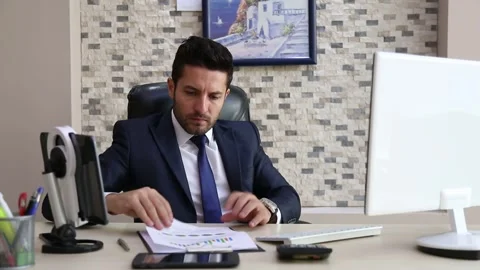 Businessman Entering Data While Reviewing Financial Charts Video stock 346183799