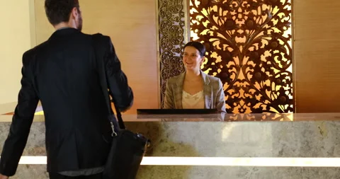 Businessman entering in hotel lobby for checking in. Young businessperson and Stock Footage