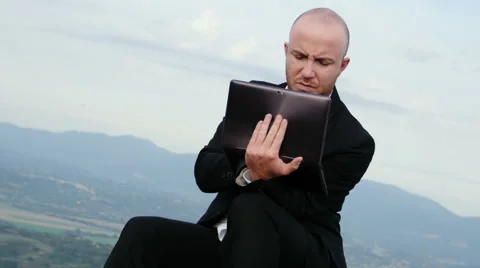 Businessman escapes from work and checks his tablet 스톡 동영상 59122426