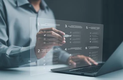 Businessman evaluating questionnaire on laptop computer on internet website Stock Photos