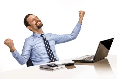 Businessman excited with his success while working with his laptop computer Stock Photos