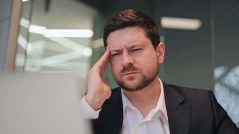 Businessman Experiencing Headache While Working in Office Stock-Footage 330386735