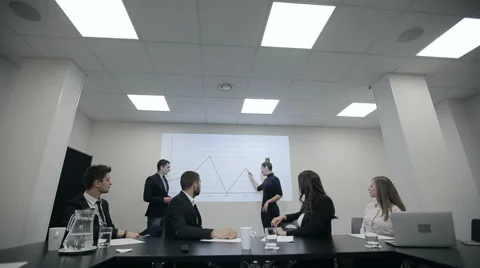 Businessman explaining bar chart to colleagues in a conference room Stock Footage 58194019