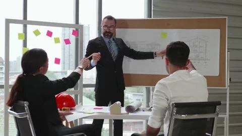 A businessman explaining construction plan projects training a business team. Stock Footage 139634611