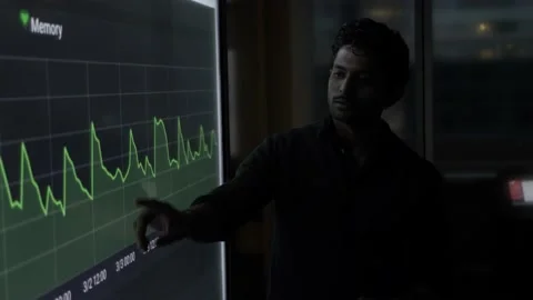 Businessman explaining data at touch screen in dark office meeting Stock Footage 221039894