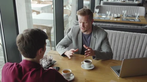 Businessman explaining points to colleague Stock Footage 111756504