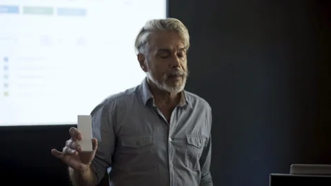 Businessman explaining presentation on projection screen Stock Footage 106303999