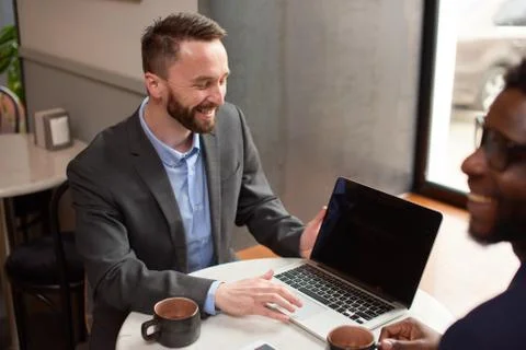 Businessman explains to another contract terms at lunch Stock Photos