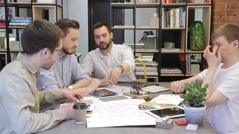 Businessman explains his colleagues the design in office. Stock Footage