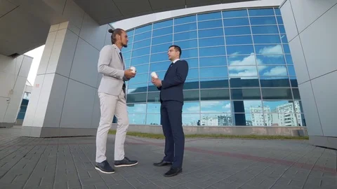Businessman explains to the partner in terms of cooperation in an informal Stock Footage 77935184