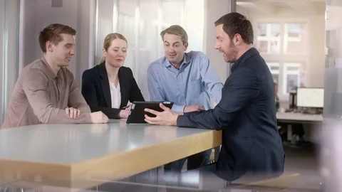 Businessman explains sales on a tablet Stock Footage 72336089
