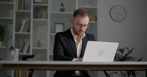 Businessman with eyeglasses wearing classical clothes working on laptop. Stock Footage 249181553