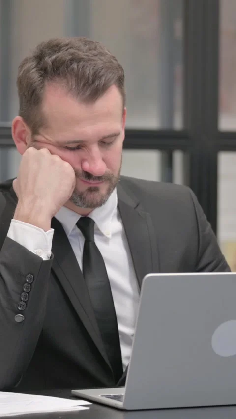 Businessman Falling Asleep while Working on Laptop, vertical video Stock Footage 324795729