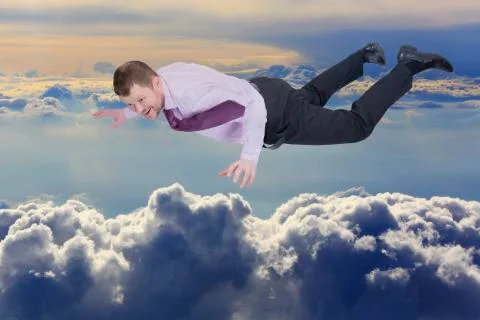 Businessman falling down over clouds in background Foto stock