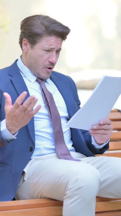 Businessman Feeling Upset while Reading Contract Outdoor, vertical 스톡 동영상 321119566