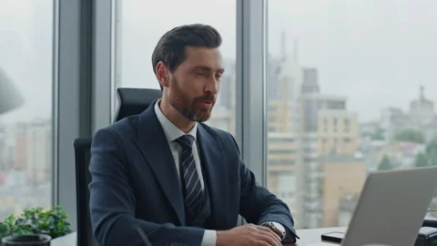 Businessman finishing online interview using laptop in modern office close up. Video stock 227953816