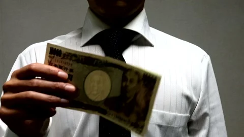 A businessman fluttering banknotes Stock Footage 335470362