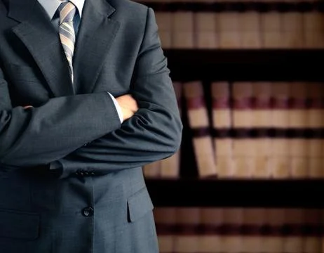 Businessman in front of bookcase Stock Photos