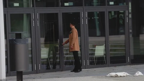 A businessman in front of a closed door pulls a handle outside Stock Footage 126556388