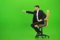 The businessman fun on the chair on the green background Photo