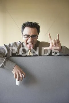 Businessman gesturing over cubicle wall Stock Photos