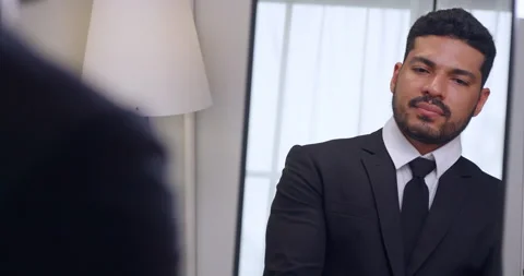 Businessman gets dressed in front of the mirror before going to work. Stock Footage 270505380